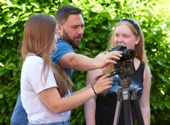 Media lecturer working with media students